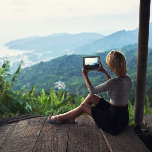 Back,View,Of,A,Young,Woman,Wanderer,Is,Making,Photo